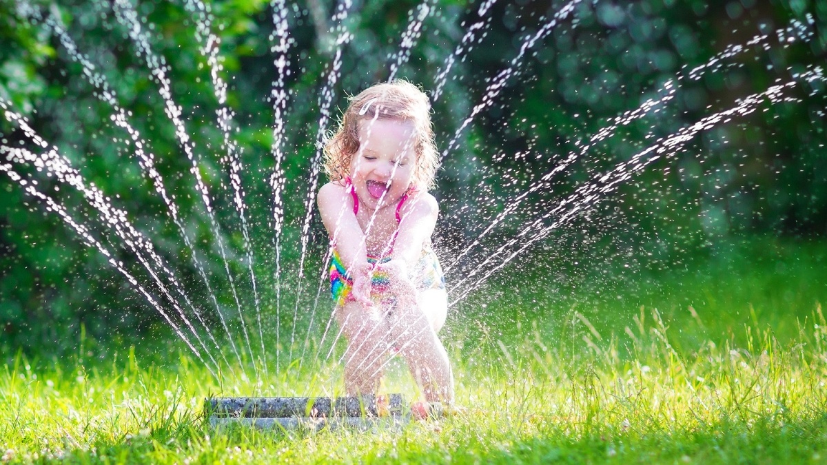 Splish splash. Kids Garden Summer Water game. Play in the Sprinkler. Run through Sprinklers. Summer, Water, children.